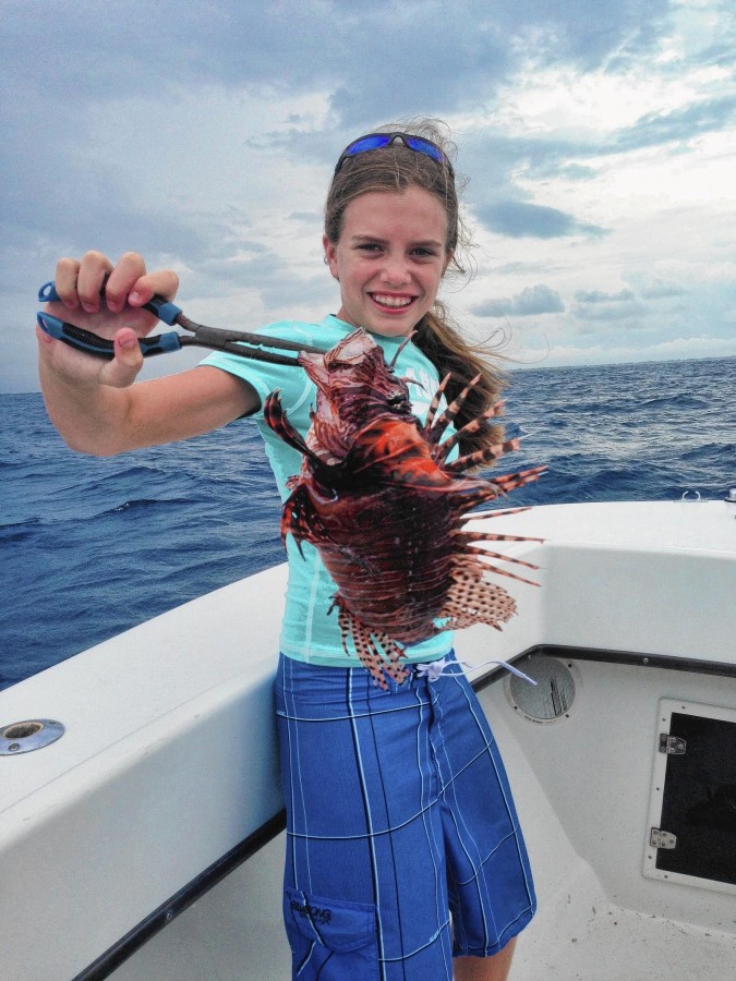 Lauren Arrington holds up a lionfish speared off the coast of Jupiter. (Courtesy of Albrey Arrington, Handout)